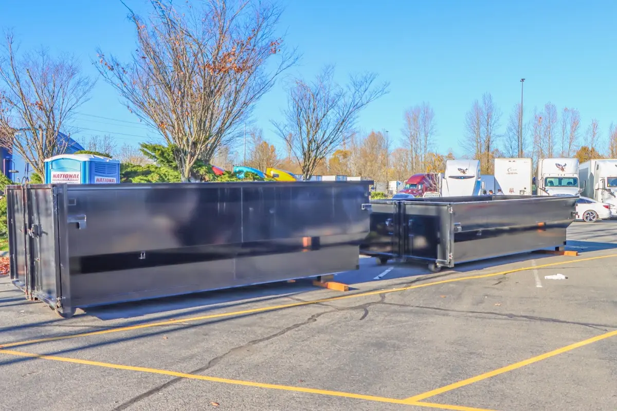 Professional dumpster rental service with roll-off container on residential driveway in Idaho Falls